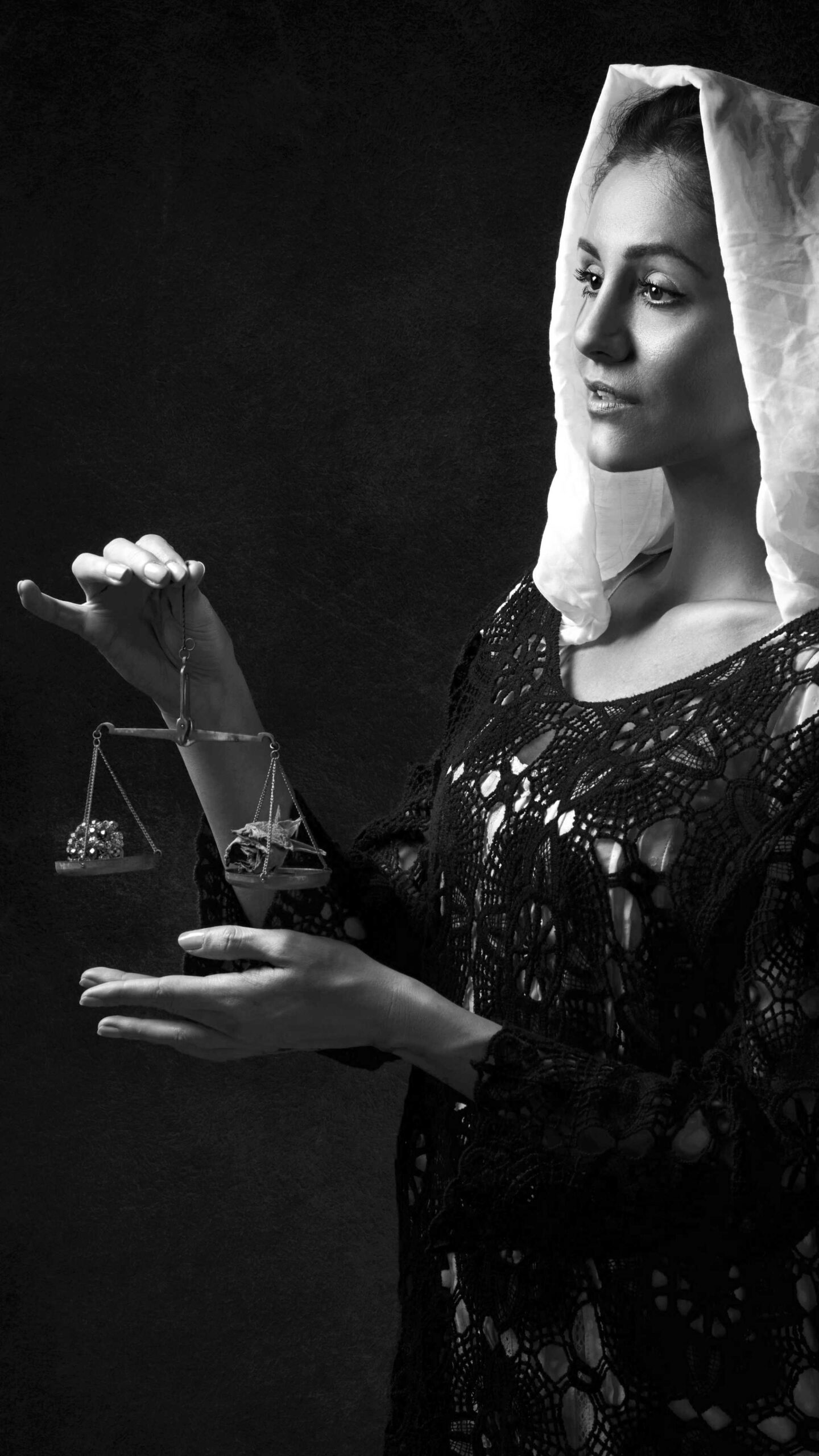 (People) (Affinity) woman holding up sokme balancing scales, has